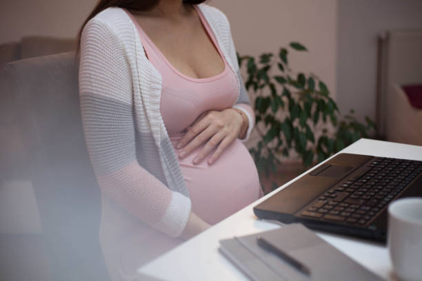 istock Pregnant woman working on laptop. 1131360451