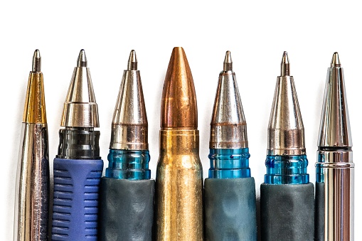 Bullet and pens on white background. Freedom of the press is at risk concept. World press freedom day concept.
