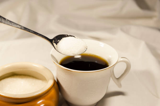 istock Pouring sugar in the cup of coffee 1131361926