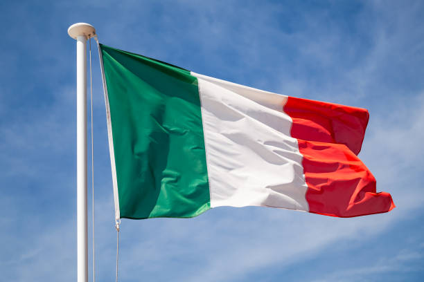 istock Flag of Italy waving on wind over sky 1131362498