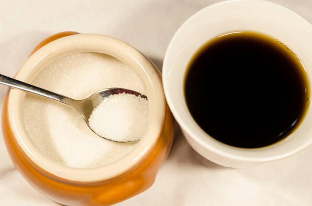 istock Pouring sugar in the cup of coffee 1131362516