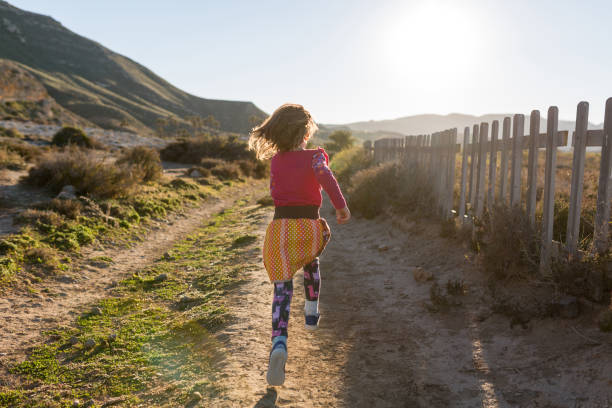Little girl running through the Spanish landscape, Rambla del Playazo, Cabo de Gata - Nijar Natural Park, Spain Little girl running through the Spanish landscape, Rambla del Playazo, Cabo de Gata - Nijar Natural Park, Spain cabo de gata photos stock pictures, royalty-free photos & images