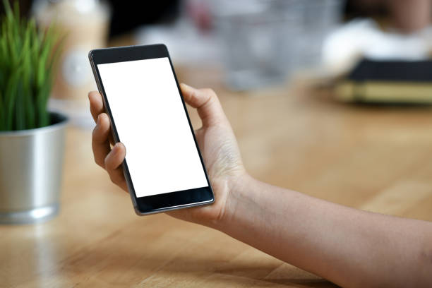 istock Girl with a blank screen mobile smartphone in her hand. 1131363176