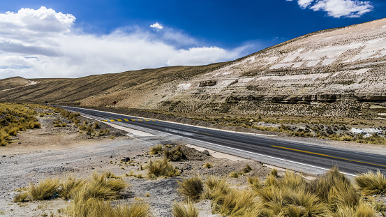 The highway runs on a wide plateau in the Central part of the Andes in Peru.