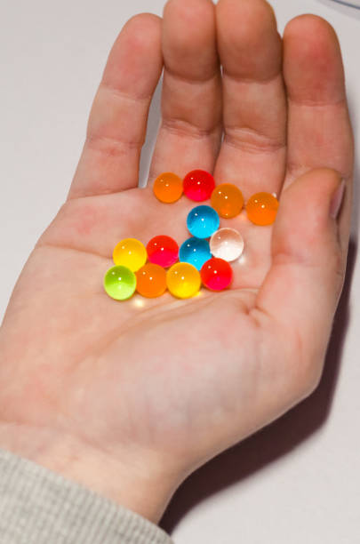 istock Colored balls of hydrogel in the hands 1131364433