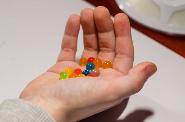 istock Colored balls of hydrogel in the hands 1131364524
