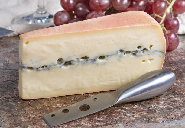 istock Morbier semi-soft cow milk French cheese with black mold layer 1131365255