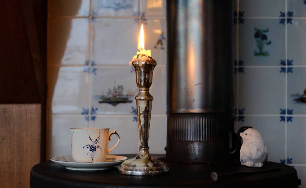 istock Candle and a cup of tea on a stove 1131368360