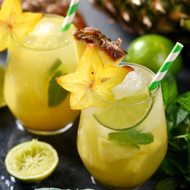 istock Cold tropical cocktail with crushed ice, carambola, pineapple, lime and mint, square image 1131368889