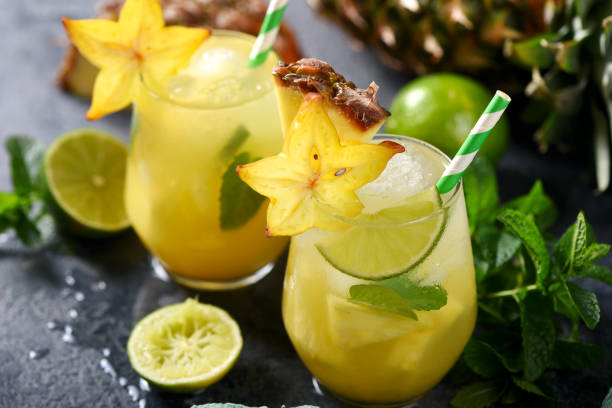 istock Cold tropical cocktail with crushed ice, carambola, pineapple, lime and mint, refreshing lemonade drink 1131368910