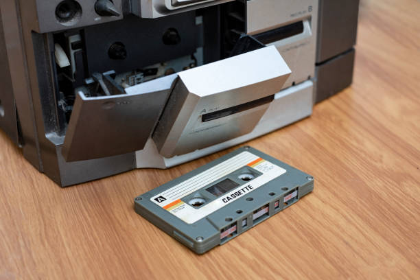 istock Vintage compact cassette and audio tape player on table wood background 1131369037