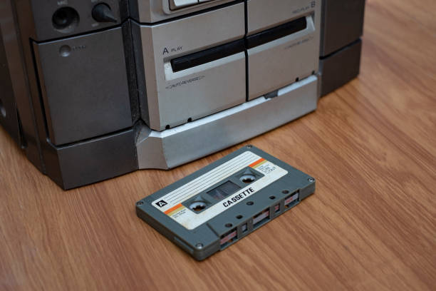istock Vintage compact cassette and audio tape player on table wood background 1131369091