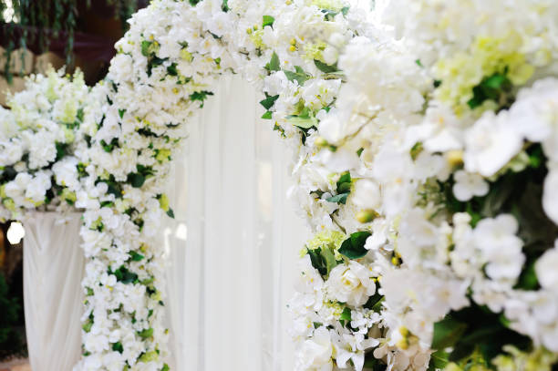 istock Wedding arch of white orchids and roses 1131370451