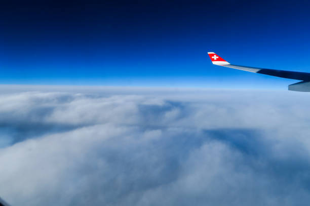 Air, India, 3 sept 2017: Flight from Switzerland to Kenya with the company Swiss. View out of the window. Clouds covering the ground, beautiful dark blue sky.