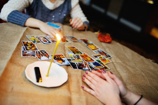 Divination by the Tarot cards. The fortune teller predicts the f Divination by the Tarot cards. The fortune teller predicts the fate of the cards psyche photography stock pictures, royalty-free photos & images
