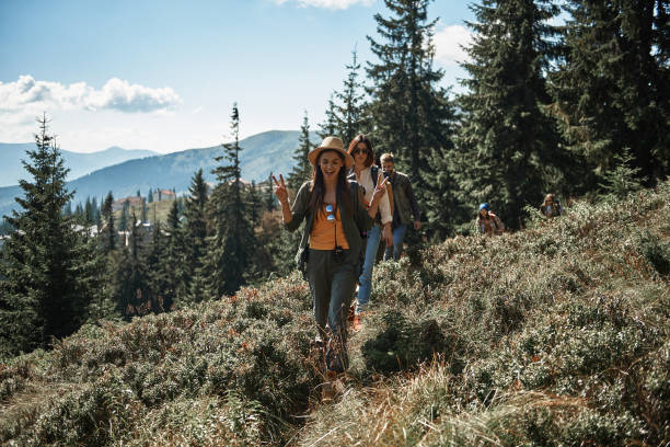 istock Positive friends walking along the path in the mountains 1131372615