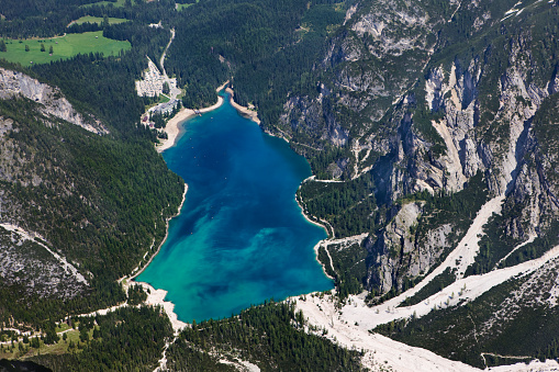 Scenic mountain landscape of the Dolomite alps with remote turquoise and blue colored lake Pragser Wildsee. Natural landmark and famous travel destination. Aerial view from high up, on top of the mount Seekofel in the nature reserve Fanes-Sennes-Prags. XXXL (Canon Eos 1Ds Mark III)