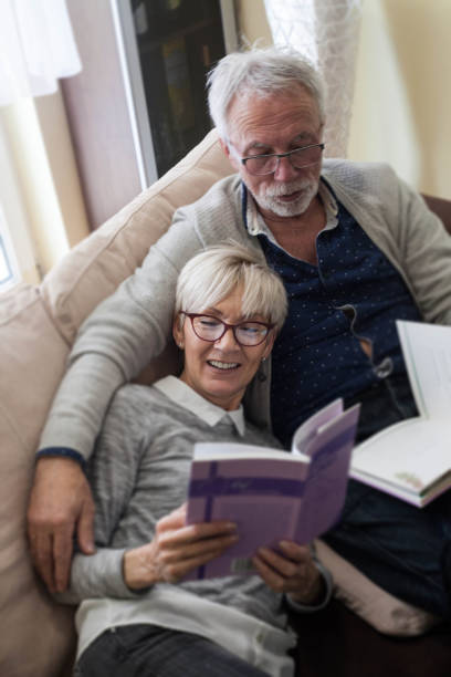 istock Couple reading and watching TV. 1131372939
