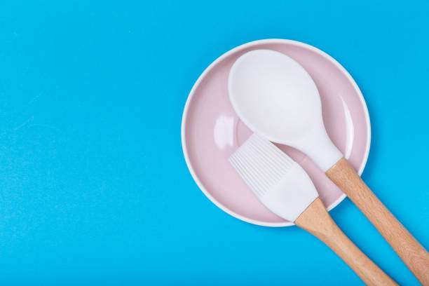 istock kitchen utensils on a saucer on blue background 1131374331