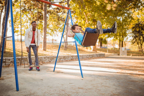 istock Fathers day. Father and son playing in public park 1131378617