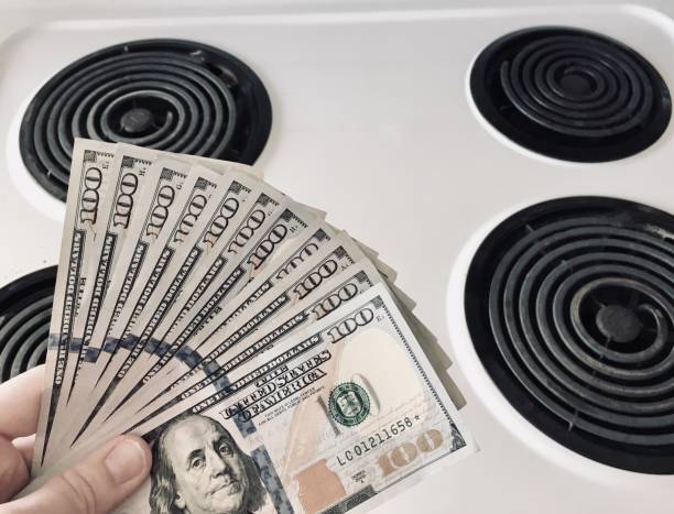 istock Money and Stove 1131378961