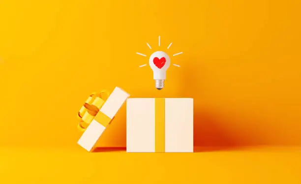 Photo of Shopping And Gift Concept- A Light Bulb With Heart Shape Coming Out Of White Gift Box