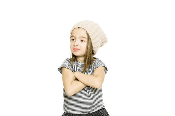 Confident little girl posing over white background