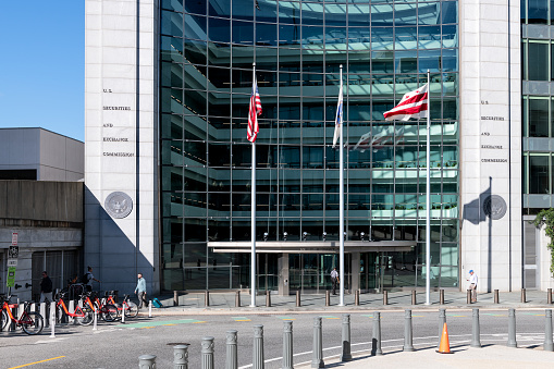 Washington DC, USA - October 12, 2018: US United States Securities and Exchange Commission SEC architecture by empty street road with modern building sign and logo with flag glass windows