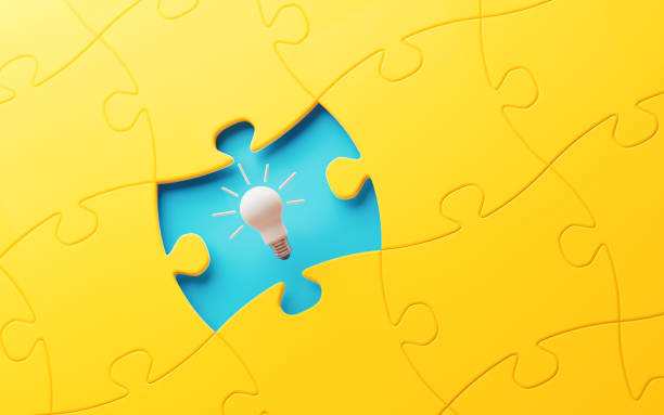 istock Light Bulb And Yellow Jigsaw Puzzle Piece Over Blue Background 1131386547