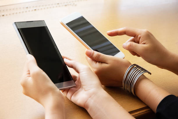istock The hipster girl using mouile phone,touching on screen ,hipster hands texting mobile phone, 1131386551