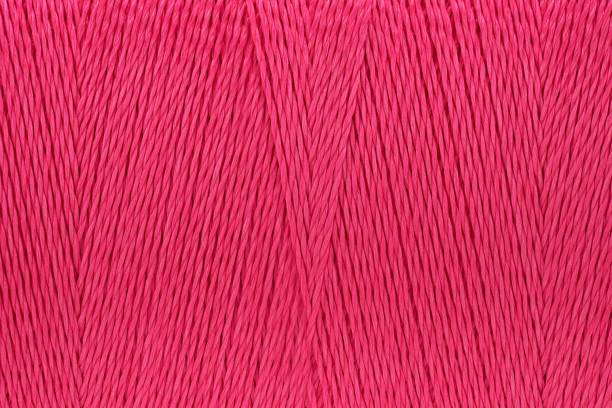 istock Macro picture of thread texture pink color background 1131387711