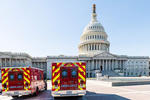 Washington DC, USA - October 12, 2018: US Congress dome construction exterior on Capital capitol hill with ambulance red fire trucks