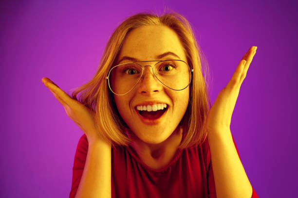 istock Beautiful woman looking suprised isolated on neon background 1131389032