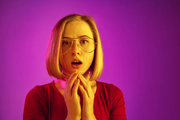 istock Beautiful woman looking bewildered isolated on pink 1131389050