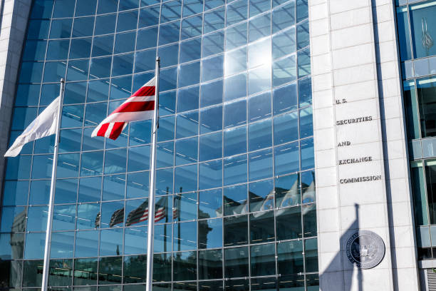 united states securities and exchange commission sec architecture closeup with modern building sign and logo with red flags by glass windows - washington dc architecture nobody american flag imagens e fotografias de stock