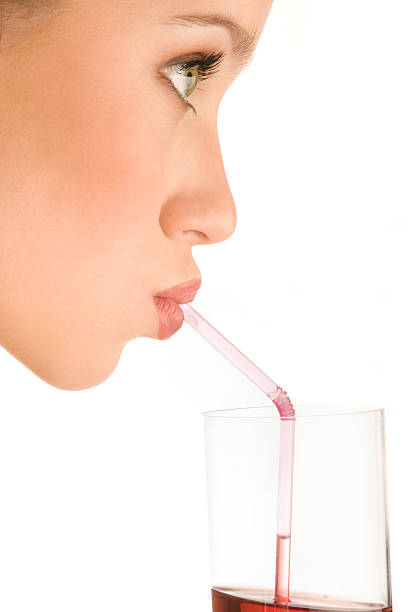 Drinking juice. Side view, close-up. stock photo