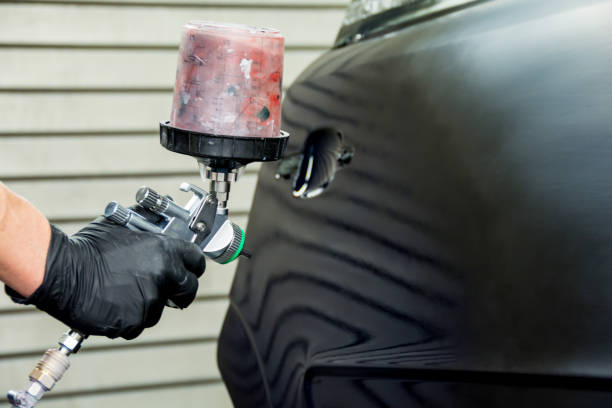 istock a car painter paints the fender of a car 1131389934