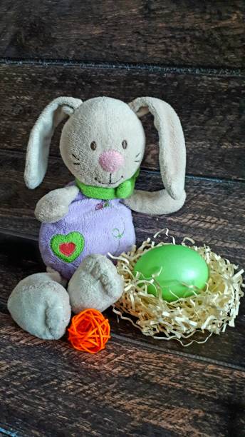 istock Easter bunny with egg in a nest of straw. 1131391330