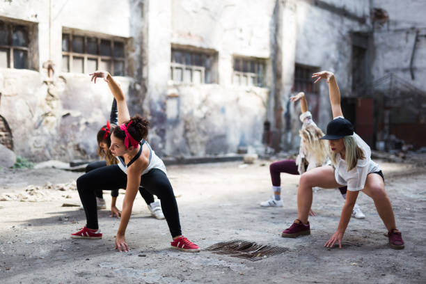 istock Group of female break dancers are performing in old storage 1131391622