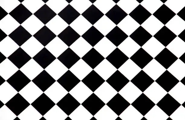 Photo of Black and white checkered floor tiles seamlessly as a pattern, top view