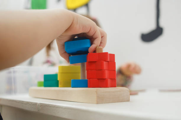 istock Toddlers playing multicolored educational games, mosaic and puzzles table 1131395495