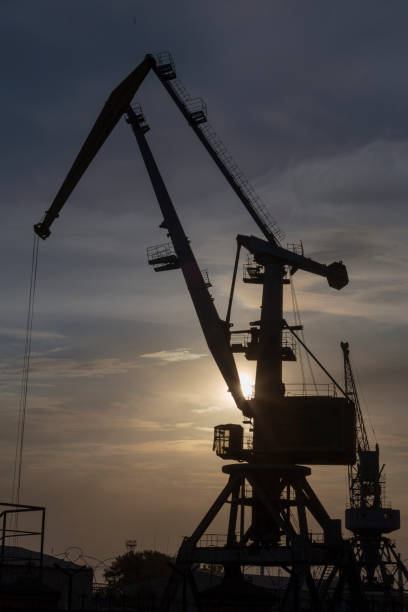 istock silhouette of port cranes at sunset 1131396809