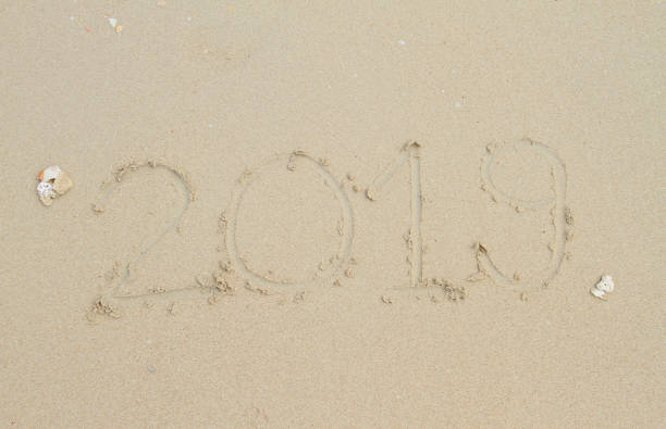 istock Happy new year.2019 handwritten on sandy beach 1131397077