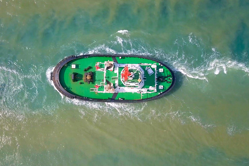 Tug boat at sea - Top down aerial image.