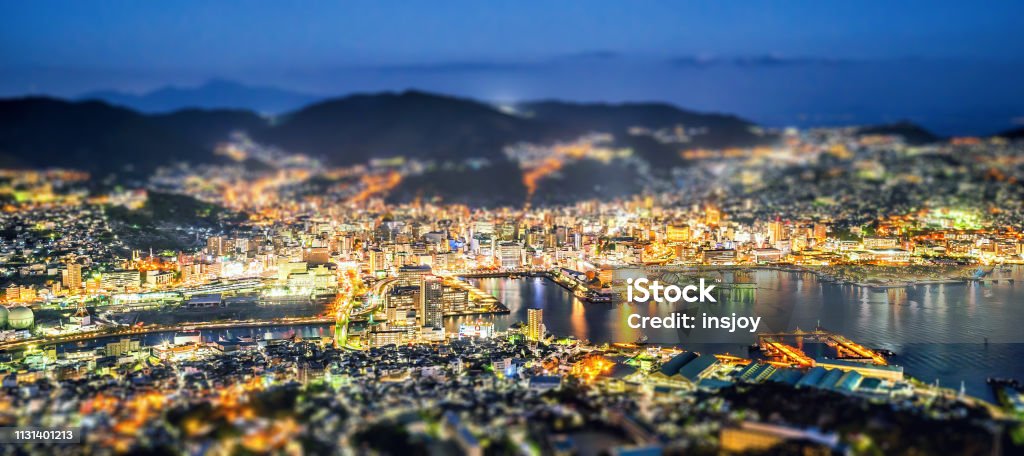 Business concept, tilt shift effect modern cityscape of nagasaki dusk from mount inasa, the new top 3 nightview of the world, aerial view, copy space Aerial View Stock Photo