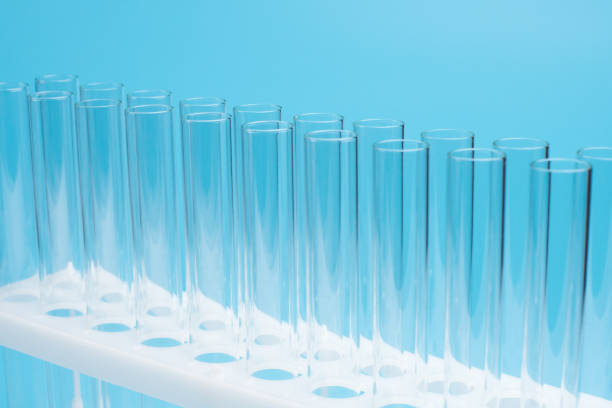istock Glass test tubes in a stand on blue background. Laboratory test tubes,science background abstract 1131405589