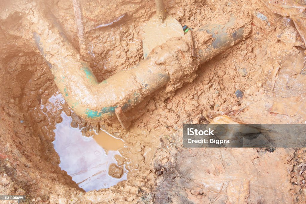 broken pipe in hole with water motion at roadside wait repair Sewage Treatment Plant Stock Photo