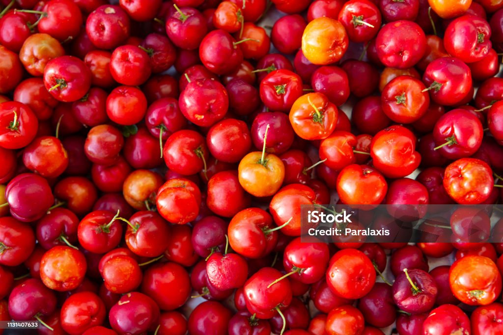 Close up of fresh "Acerola" cherry fruits. The "acerola" berries juice contains 40 to 80 times more vitamin "C" than lemon or orange juice. Acerola Stock Photo