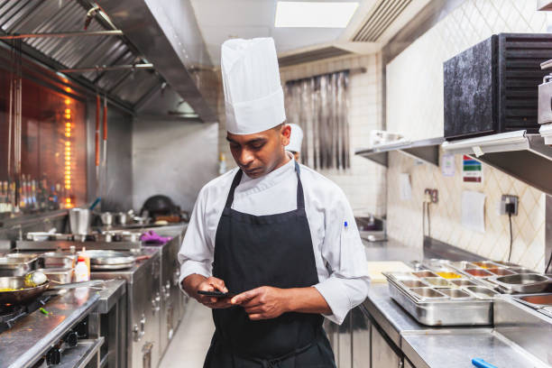 Chef Using Phone to Check a Message During Break stock photo
