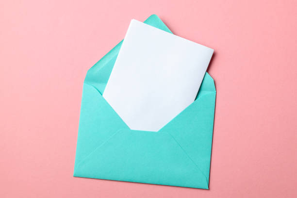 istock Green envelope and blank letter on pink background 1131408466